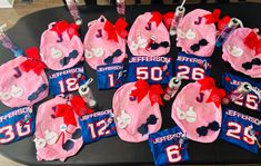 a table topped with pink and blue cake covered in minnie mouse hats, ribbons and decorations