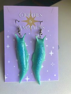 These slimy looking slugs are perfect for lovers of creepy crawlers. Charge them in the light and watch them glow!  I am able to make almost any color glow, so feel free to message me if you're interested in a custom order.  Please note:  All of my items are handmade to order. This means you will receive a unique, one-of-a-kind item that may differ slightly from the photos. Please allow extra processing time while I perfect your order! Worm Polymer Clay, Polymer Clay Slug, Creepy Clay Earrings, Weird Clay Earrings, Cool Clay Earrings, Clay Slugs, Unique Polymer Clay Ideas, Polymer Clay Ideas Aesthetic, Polymer Clay Bugs