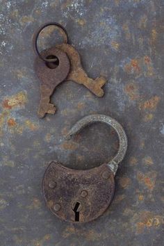 an old rusty padlock with a key on it