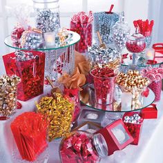 a table topped with lots of different types of candy and candies on top of glass trays