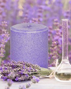 a lavender candle and some flowers on a table