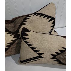 two black and white pillows sitting next to each other