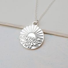 "Gorgeous Happy Place Ocean Necklace featuring a calming image of the sun over sparkling waves. The detailed but classic design is etched into the surface of the metal which catches the light and sparkles in the sun. The necklace serves as a reminder of those moments of happiness and calm, perfect for those who love the sea. -*- UNIQUE DESIGN -*- This piece has been illustrated, designed and hand-finished by Cassie in her Suffolk studio and is totally unique to Cassiopi. -*- PENDANT -*- * 1.6cm Sunset Necklace, Sea Necklace, Ocean Necklace, Moon Phases Necklace, Beach Necklace, Wave Necklace, Metalsmithing Jewelry, Surfer Necklace, Metal Clay Jewelry