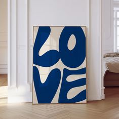 a blue and white abstract painting on the wall