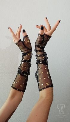 Limited edition! This pair of fingerless gloves is made of tulle with gold foil stars and feature a separate thumb. They're perfect to grade up any witchy, goth or evening look. ** SIZE INFORMATION ** Please select your preferred size from the bar: - Small - wrist contour: 16cm or 6 1/4'' - Medium - wrist contour: 18cm or 7'' - Large - wrist contour: 19.5cm or 7 3/4'' ** CARE INSTRUCTIONS ** Spot wash only -this will prevent early damage on the stars foil. It's highly recommended to use your hai Fairy Grunge Gloves & Mittens, Cheap White Masks For Costume Party, Luxury Artistic Masquerade Mask For Mardi Gras, Aesthetic Clothes Accessories, Elegant Luxury Brown Signet Ring, Cheap Playful Costume Accessories For Cosplay, Dark Fairytale Accessories, Cheap Festival Bracelets As Gifts, Cheap Handmade Trendy Stretch Bracelet