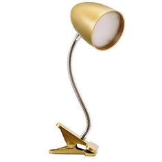 a gold desk lamp with a white light on it