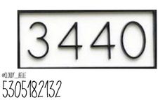 a white house number sign with black numbers