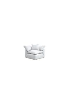 a white couch sitting on top of a white floor