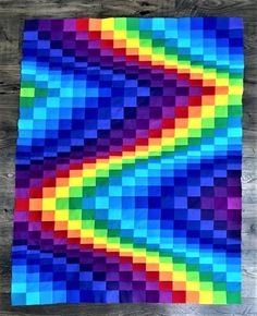 a piece of paper that has been made to look like a rainbow colored block pattern