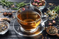 three glass cups filled with different types of tea