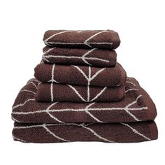 four towels stacked on top of each other in brown and white designs, with one folded up