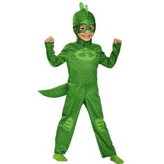 a young boy in a green costume is standing with his hands up and smiling at the camera