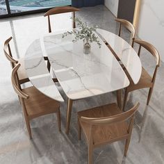 a dining table with chairs around it and a vase on the table in front of it