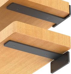 two wooden shelves with metal brackets on them