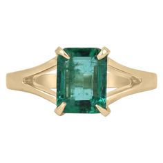 Enthrall in this stunning solitaire natural emerald ring. The gemstone showcases a fine quality Zambian emerald cut emerald with superb qualities such as excellent luster and transparency, as some of many. Set in a 14K yellow gold solitaire, four-prong setting, with a split shank and satin gold finish. Setting Style: Prong Setting Material: 14K Yellow Gold Setting Weight: 3.5 Grams Main Stone: Emerald Shape: Emerald Cut Weight: 1.36-Carats Clarity: Transparent Color: Deep Vivid Green Luster: Exc Gold And Emerald Ring, Brushed Gold Ring, Emerald Solitaire Ring, Colombian Emerald Ring, Emerald Cut Solitaire, Gold And Emerald, Gold Emerald Ring, Natural Emerald Rings, Emerald Ring Gold