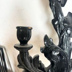 two black candlesticks sitting next to each other