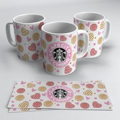 three starbucks coffee mugs with hearts on them next to a placemat and coaster