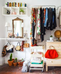 a closet with clothes hanging on the wall and an extra closet storage idea