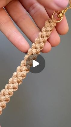 a person is holding a gold chain in their hand and the video shows how to make it