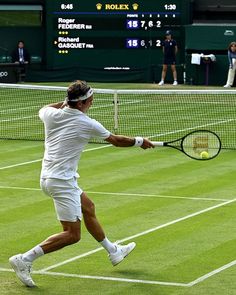 a man swinging a tennis racquet on top of a tennis court