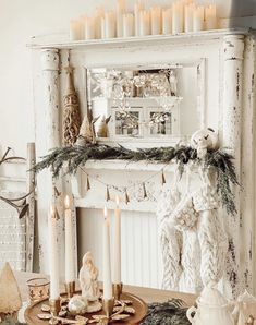 a christmas mantle with candles and ornaments on it