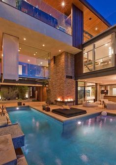 an indoor swimming pool in front of a modern house