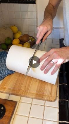 a person cutting up some food on a cutting board