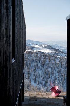 a red chair sitting on top of a wooden building