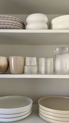 white dishes and plates on shelves in a kitchen