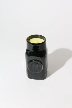 a black candle holder sitting on top of a white table