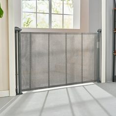 a room with a window and a metal gate