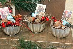 three metal bowls filled with christmas decorations on top of a table