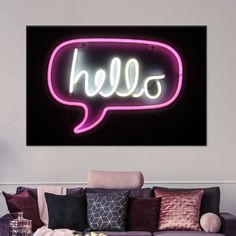 a living room filled with furniture and a neon sign on the wall that says hello