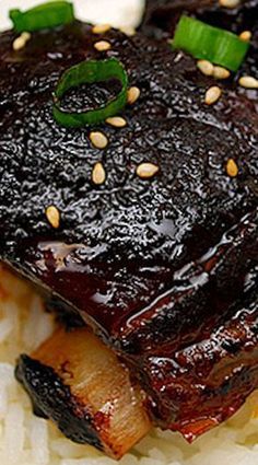 a close up of food on a plate with rice and green pepper garnish