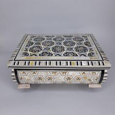 an elaborately decorated box with geometric designs