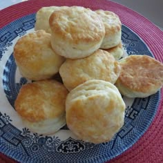 some biscuits on a blue and white plate with a red mat in the back ground