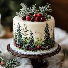 a christmas cake decorated with evergreen and cranberries