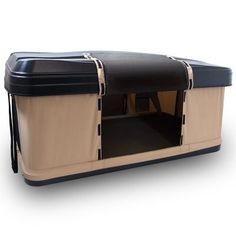 a large black and tan dog house on wheels