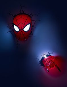 a spider - man light up wall hanging in the shape of a hand with glowing eyes