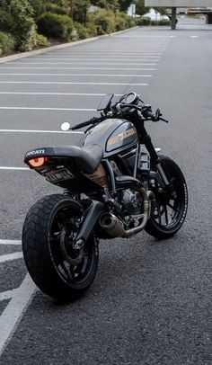 a black motorcycle parked in a parking lot