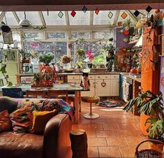 a living room filled with furniture and lots of plants