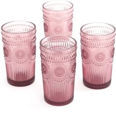 four pink glass cups sitting next to each other