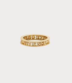 The Vivienne Westwood Westminster ring is named after the esteemed Westminster district in London, renowned for its rich history and cultural importance. The piece receives a silhouette crafted from recycled silver, adorned with a gold-tone finish that elegantly encircles the slim lettering logo on the band. Vivienne Westwood Ring Gold, Gold Vivienne Westwood, Vivienne Westwood Ring, The Vivienne, Ringe Gold, Lettering Logo, Men Trousers, Short T Shirt, Backpack Travel Bag