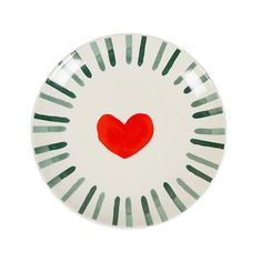 a white plate with a red heart on the center and green stripes around it, against a white background