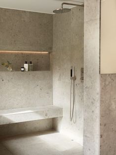 a bath room with a sink and a shower head