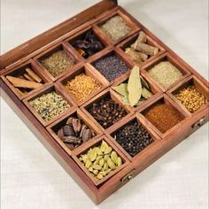 a wooden box filled with lots of different types of spices