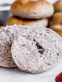 two bagels are sitting next to each other on a table with raspberries