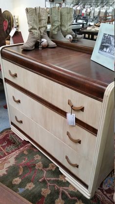 an old dresser with some boots on it