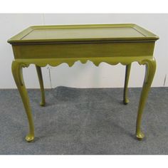 a small green table sitting on top of a carpeted floor