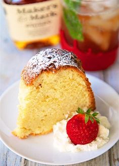 a piece of cake on a plate with a strawberry